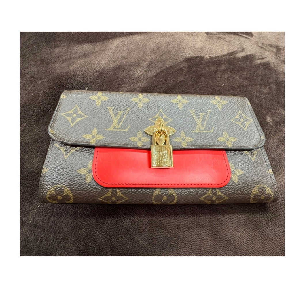Louis Vuitton Monogram Leather Wallet with Bold Red Flap and Gold Lock Clasp